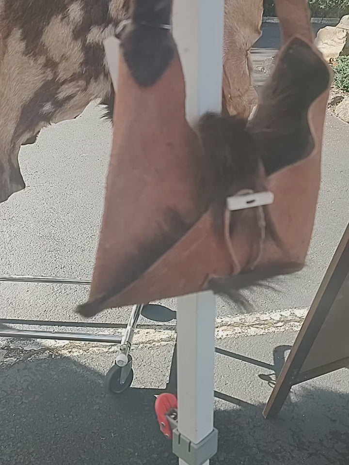 Small purse made from goat hide.