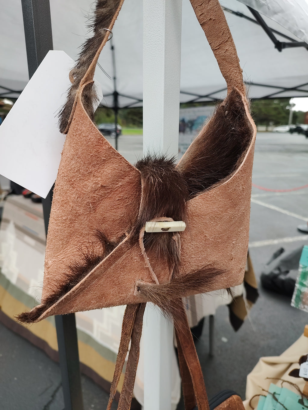 Small purse made from goat hide.