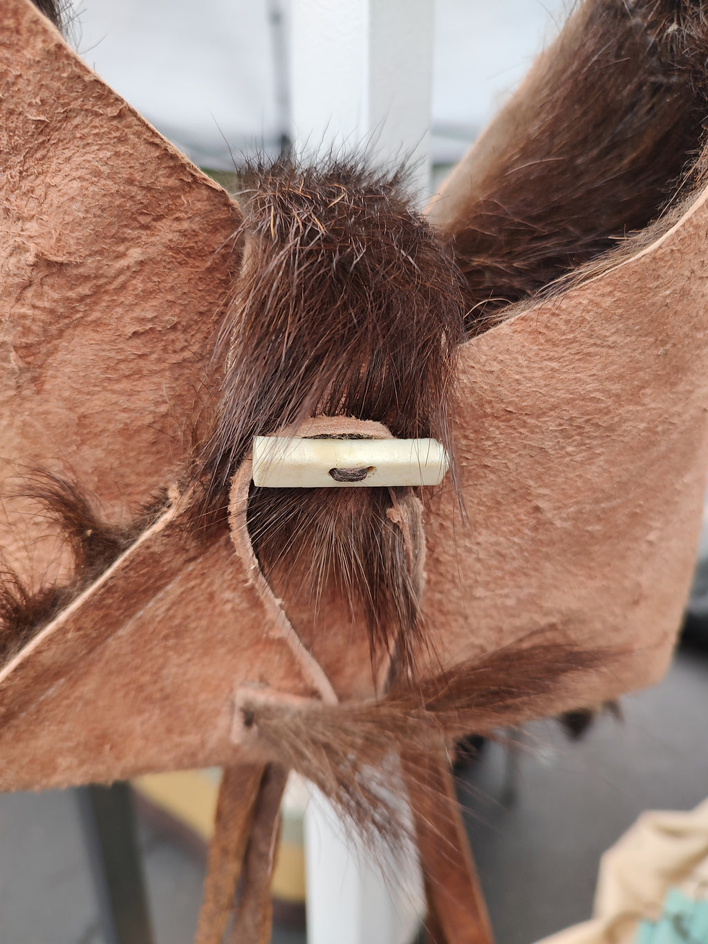 Small purse made from goat hide.